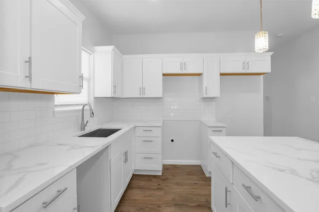 a kitchen with a sink and cabinets