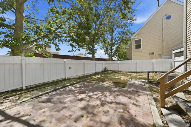 788 East Gables Street Midvale, UT 84047 - Photo 20 of 24 Fenced backyard with a paver patio and a grass area