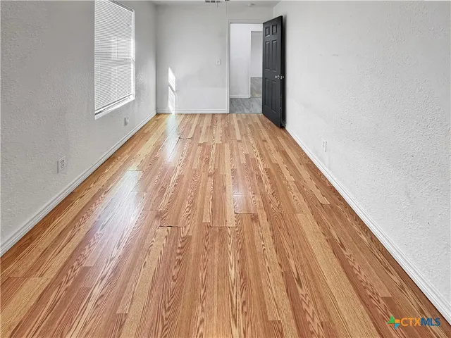 a view of wooden floor in an empty room