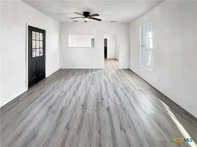 wooden floor in an empty room with a window