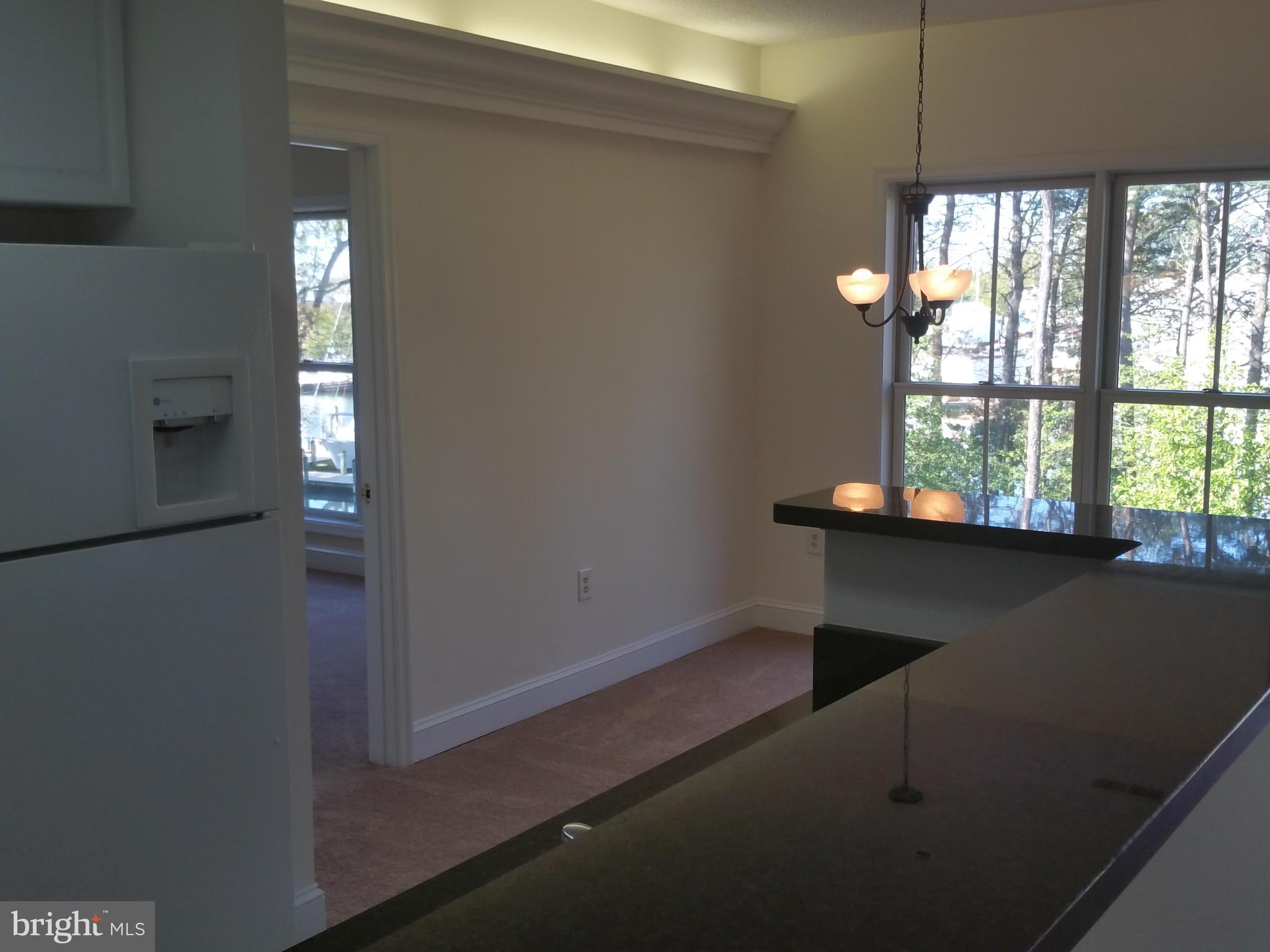 524 Runabout Loop, Unit 9 Solomons, MD 20688 - Photo 13 of 25 an empty room with windows