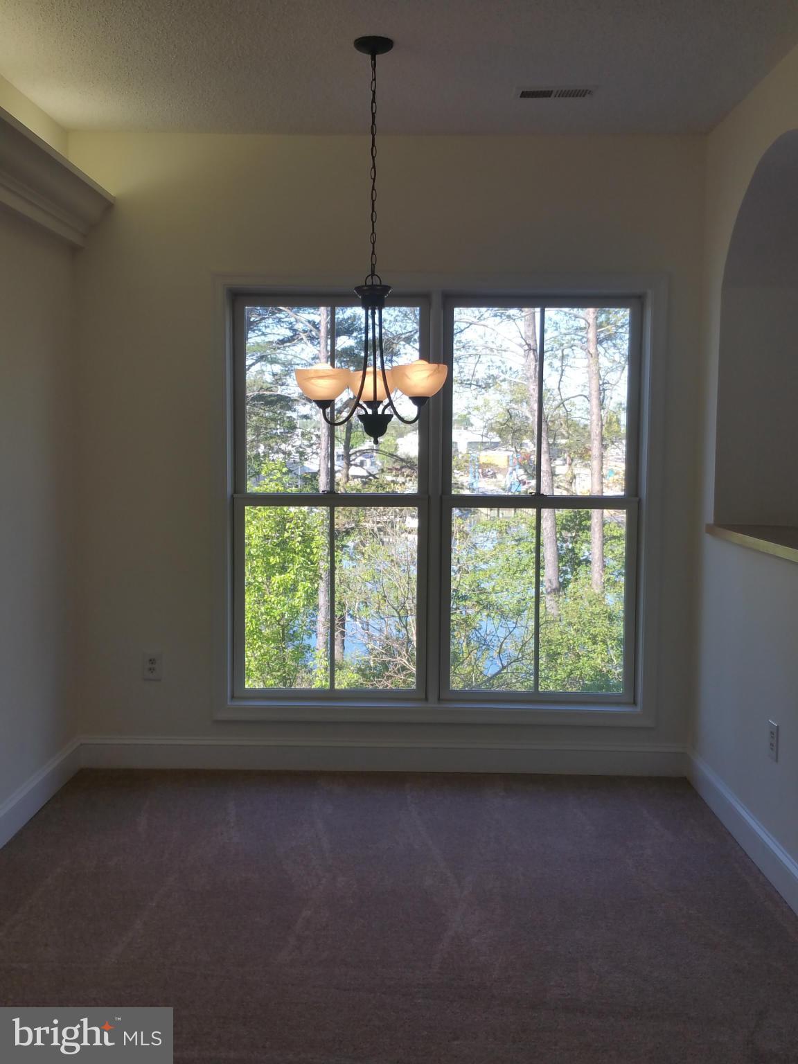 524 Runabout Loop, Unit 9 Solomons, MD 20688 - Photo 15 of 25 a view of room with window and chandelier