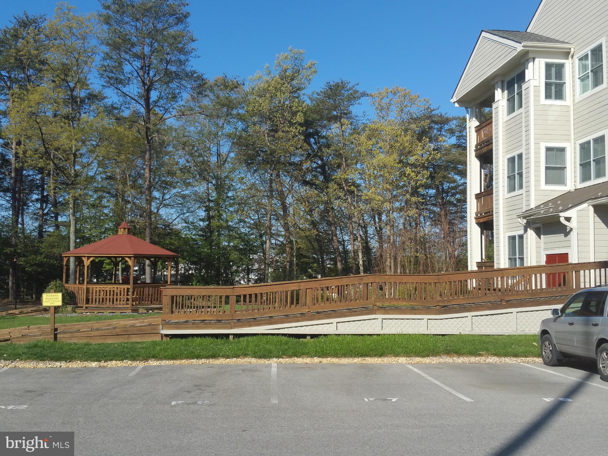 524 Runabout Loop, Unit 9 Solomons, MD 20688 - Photo 25 of 25 a front view of a house with a yard