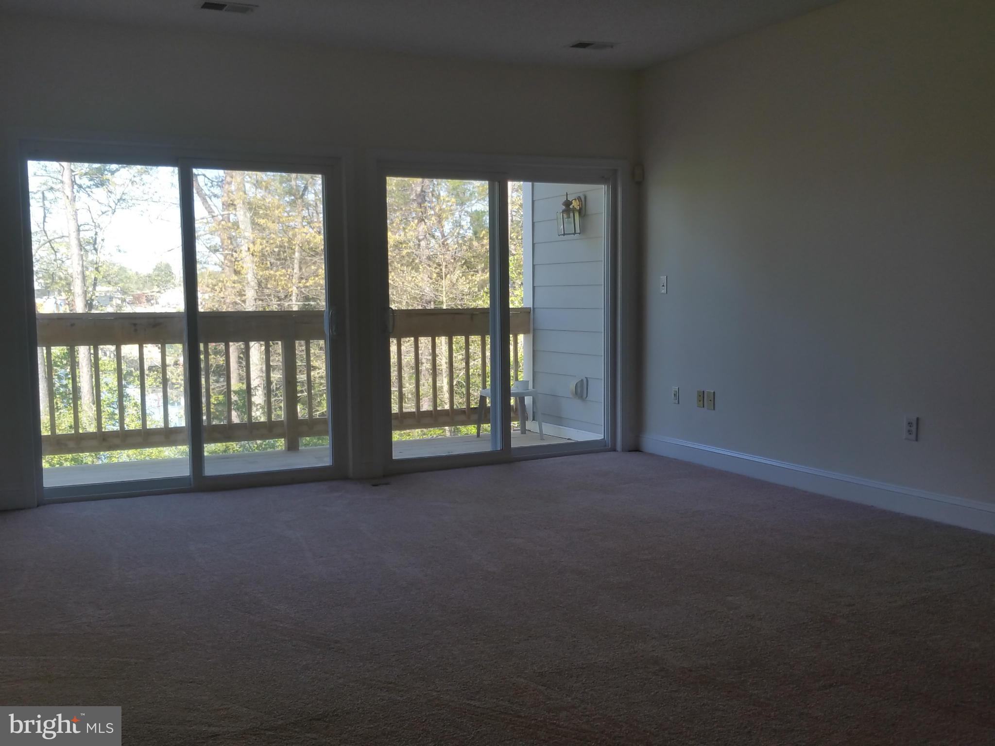 524 Runabout Loop, Unit 9 Solomons, MD 20688 - Photo 4 of 25 a view of empty room with windows