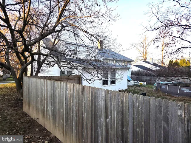a backyard of a house with wooden fence and floor