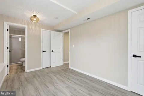 a view of a room with wooden floor closet and entryway