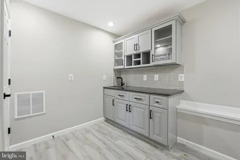 a kitchen with stainless steel appliances granite countertop a sink and cabinets