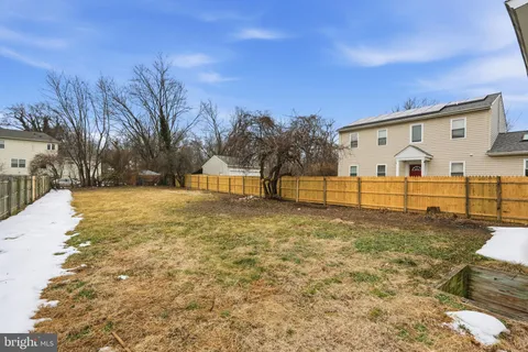 a view of a large white house with a yard
