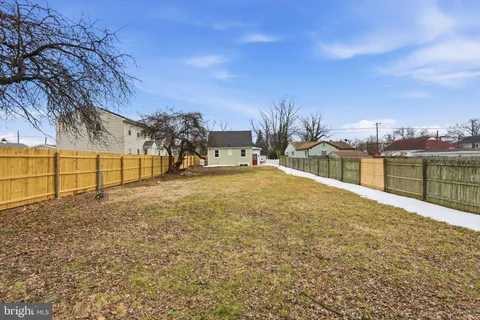 a view of a field with a building in the background