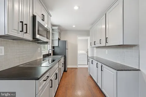a kitchen with stainless steel appliances sink microwave and cabinets