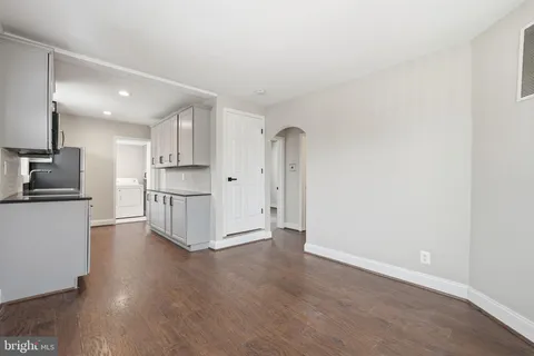a view of kitchen with wooden floor and electronic appliances