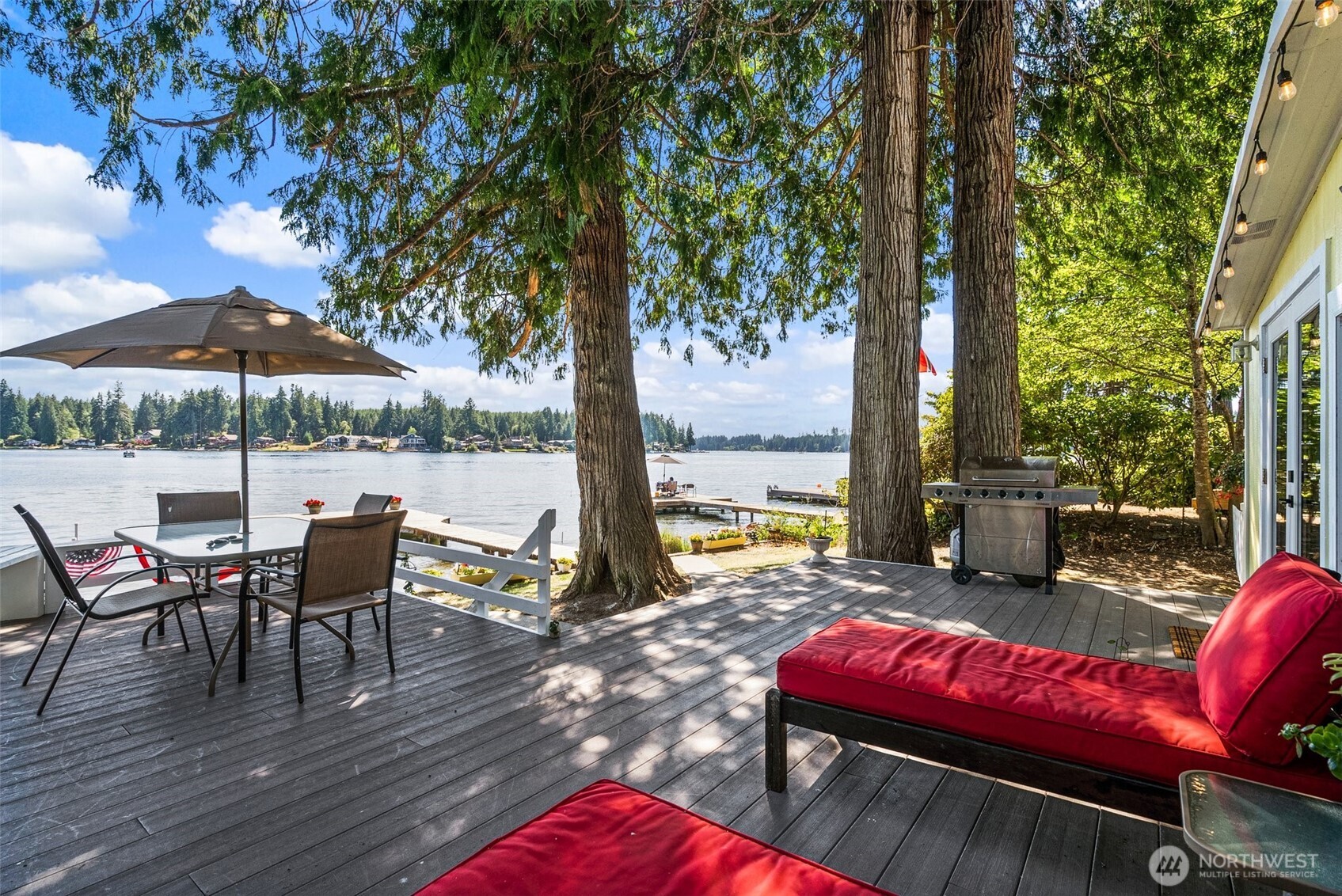 21 Shore Court Grapeview, WA 98546 - Photo 13 of 34 an outdoor sitting area with furniture and wooden floor