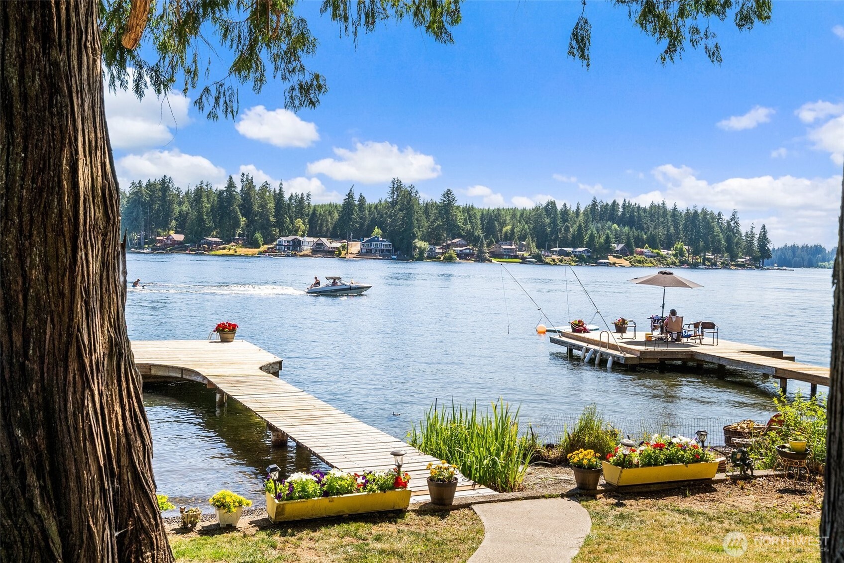 21 Shore Court Grapeview, WA 98546 - Photo 14 of 34 a view of a lake with boats and trees in the background