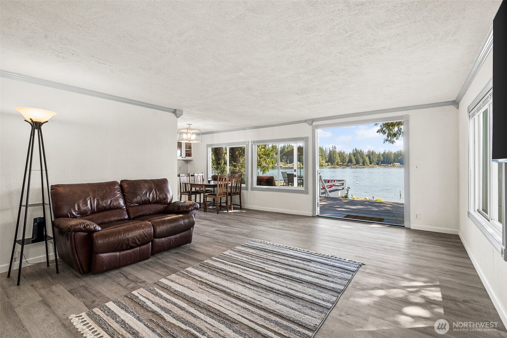 21 Shore Court Grapeview, WA 98546 - Photo 16 of 34 a living room with furniture and a floor to ceiling window