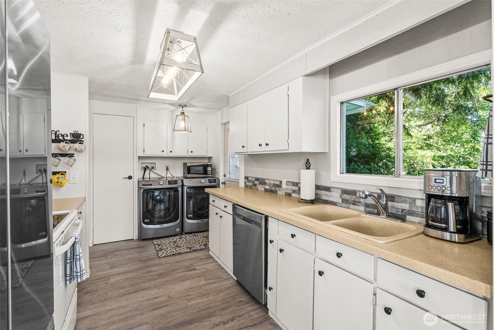 21 Shore Court Grapeview, WA 98546 - Photo 20 of 34 a kitchen with a sink cabinets stainless steel appliances and a window
