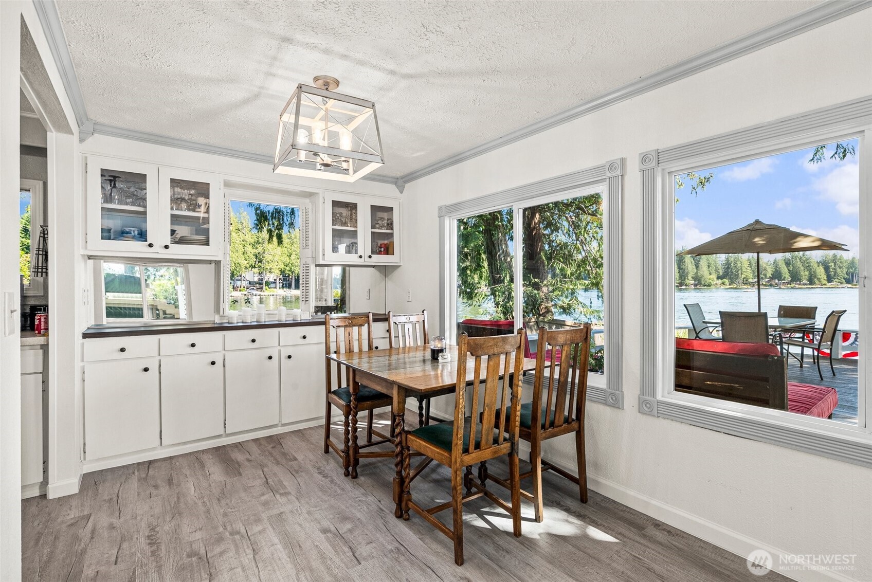 21 Shore Court Grapeview, WA 98546 - Photo 22 of 34 a view of a dining room with furniture large windows and wooden floor