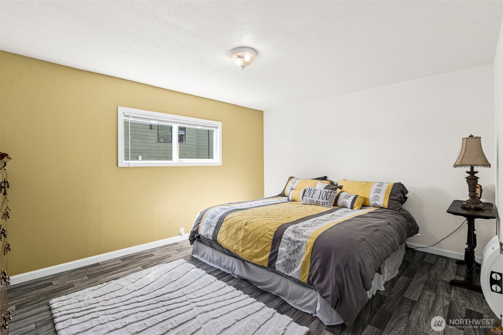 21 Shore Court Grapeview, WA 98546 - Photo 23 of 34 a bedroom with a bed and wooden floor