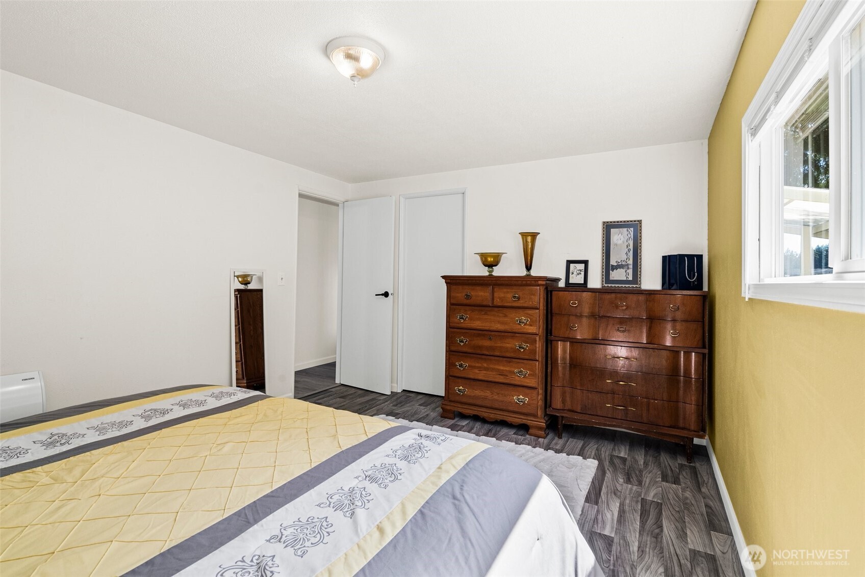 21 Shore Court Grapeview, WA 98546 - Photo 24 of 34 a bedroom with a bed and wooden floor