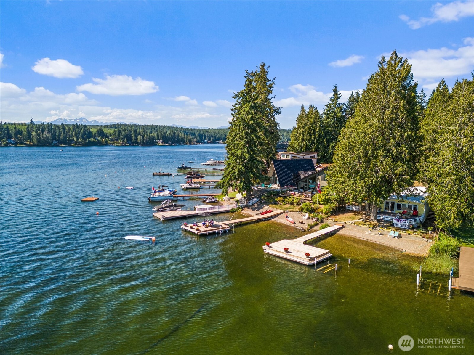 21 Shore Court Grapeview, WA 98546 - Photo 29 of 34 a view of a lake with lawn chairs