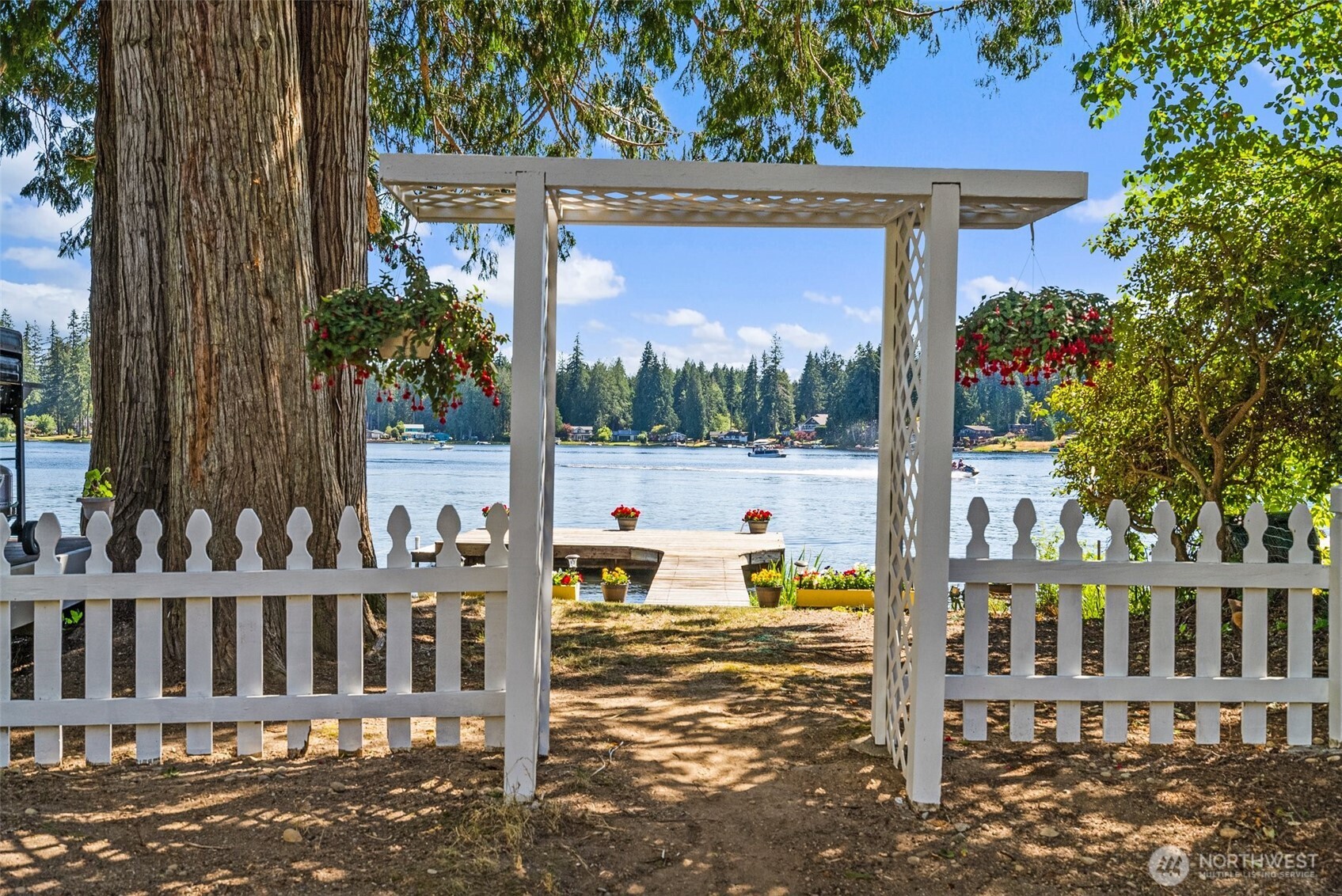 21 Shore Court Grapeview, WA 98546 - Photo 6 of 34 a view of a house with a tree and wooden fence