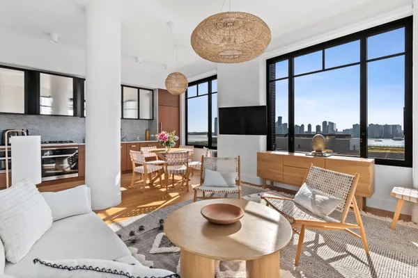 a living room with fireplace furniture and a large window