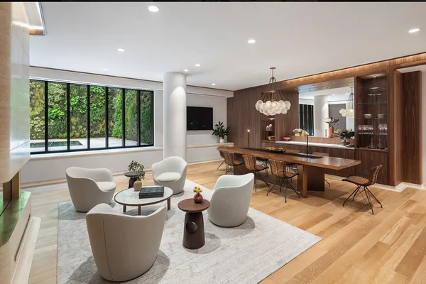 a living room with furniture and a dining table with kitchen view