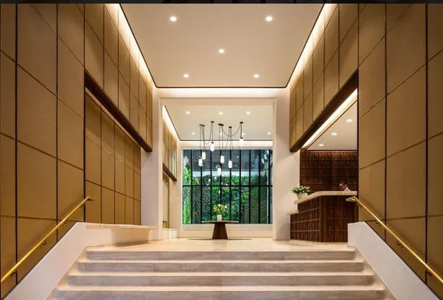 a living room with furniture a large window and kitchen view
