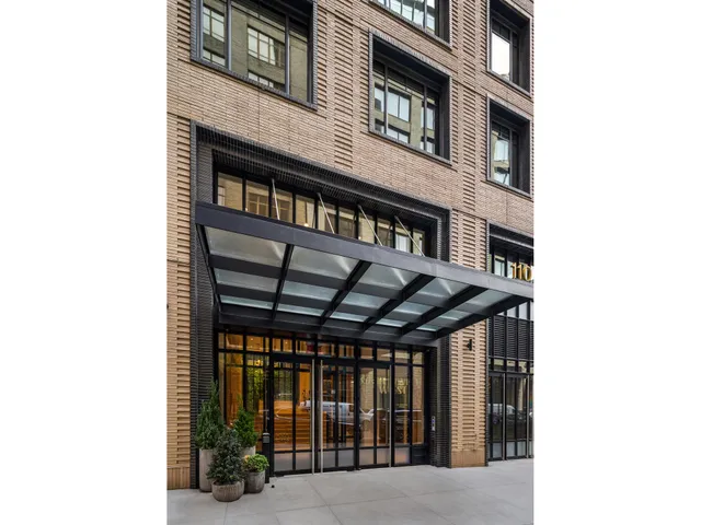 a view of a patio with table and chairs and potted plants