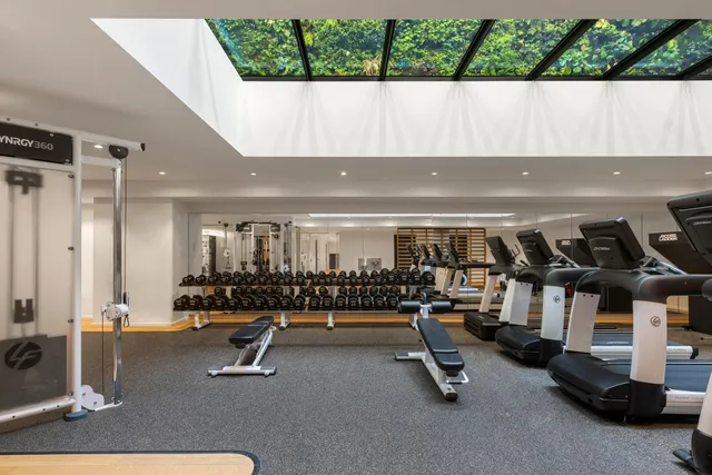 a kitchen with stainless steel appliances a large window a chandelier and living room view