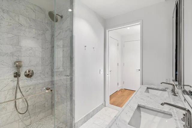 a bedroom with a large bed and a potted plant