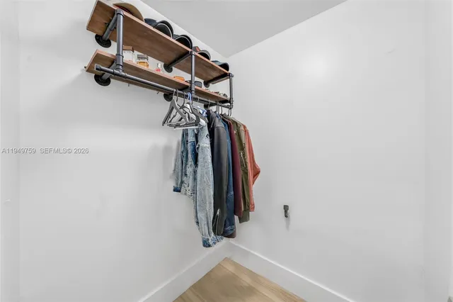 a view of walk in closet with clothes