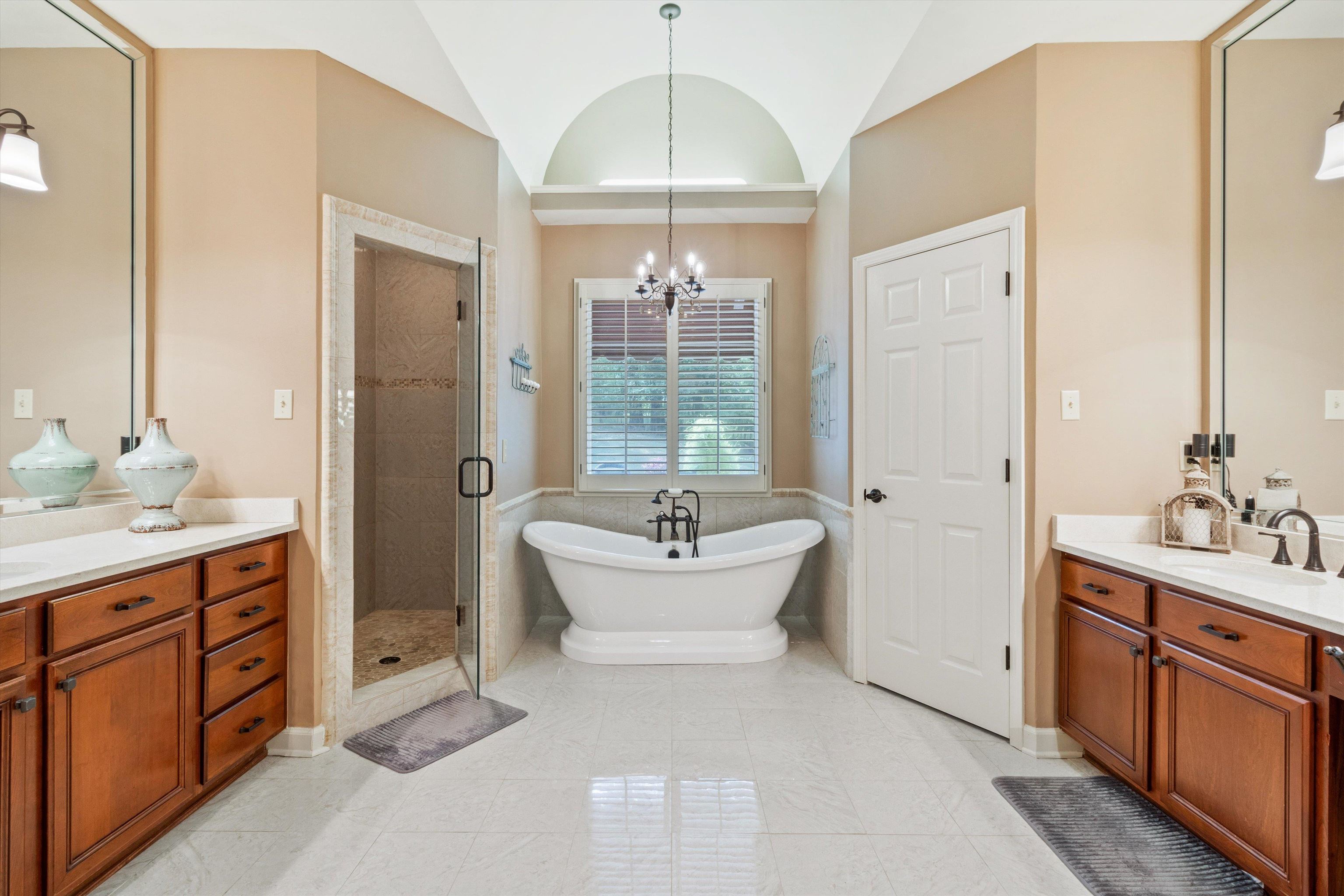 585 Hickory Lake Road Eads, TN 38028 - Photo 17 of 40 Bathroom with two vanities, a soaking tub, a chandelier, a stall shower, and high end marble floors.