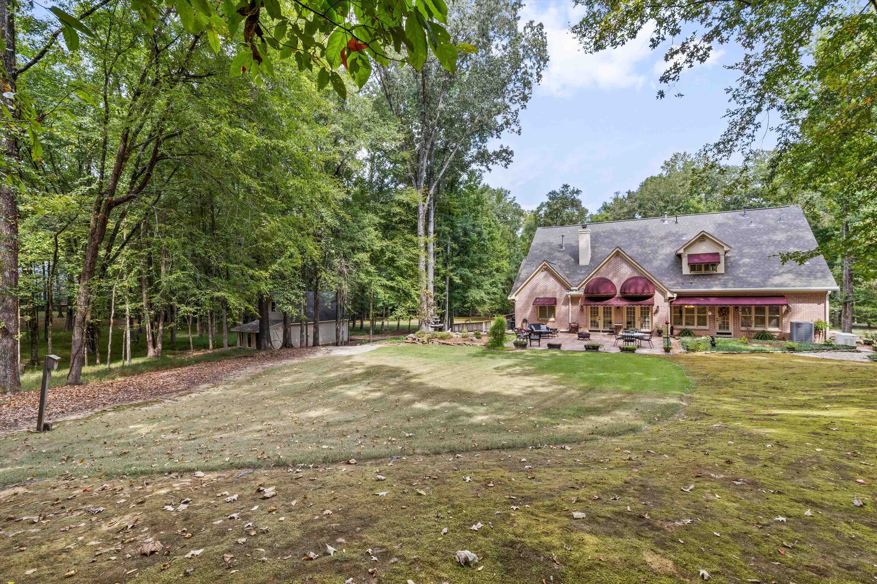 585 Hickory Lake Road Eads, TN 38028 - Photo 33 of 40 View of green lawn featuring a patio and view of scattered trees