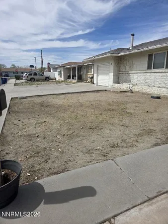 a front view of a house with parking space