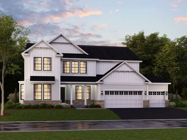 a view of a white house next to a yard and large trees
