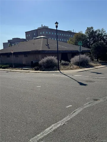 a view of a street with a building in the background