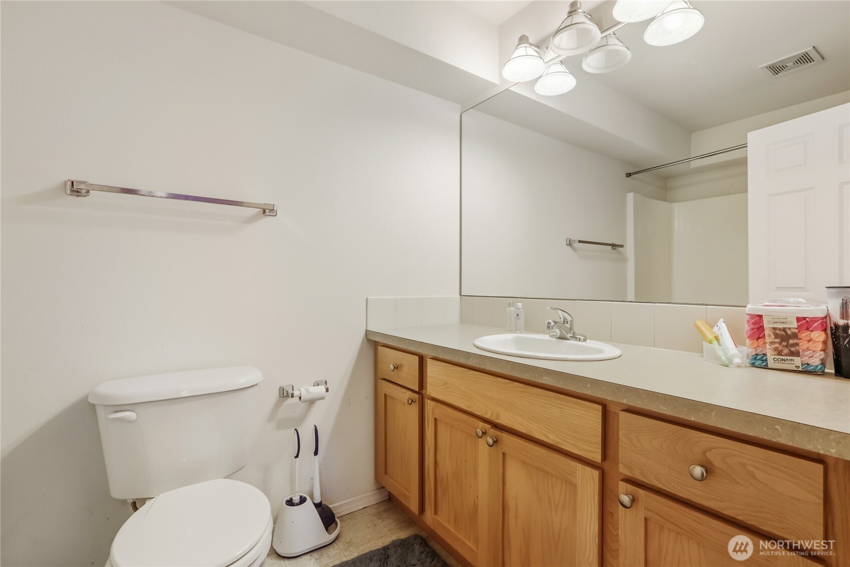 7818 228th Street Southwest, Unit 106 Edmonds, WA 98026 - Photo 11 of 19 a bathroom with a granite countertop sink vanity mirror and toilet