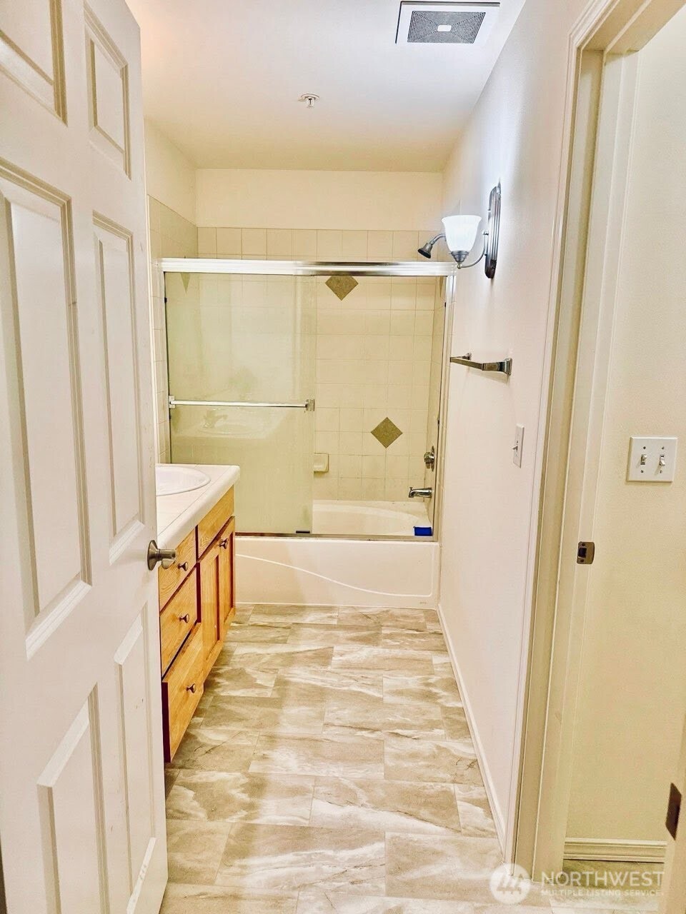 7818 228th Street Southwest, Unit 106 Edmonds, WA 98026 - Photo 13 of 19 a bathroom with a tub shower sink and vanity