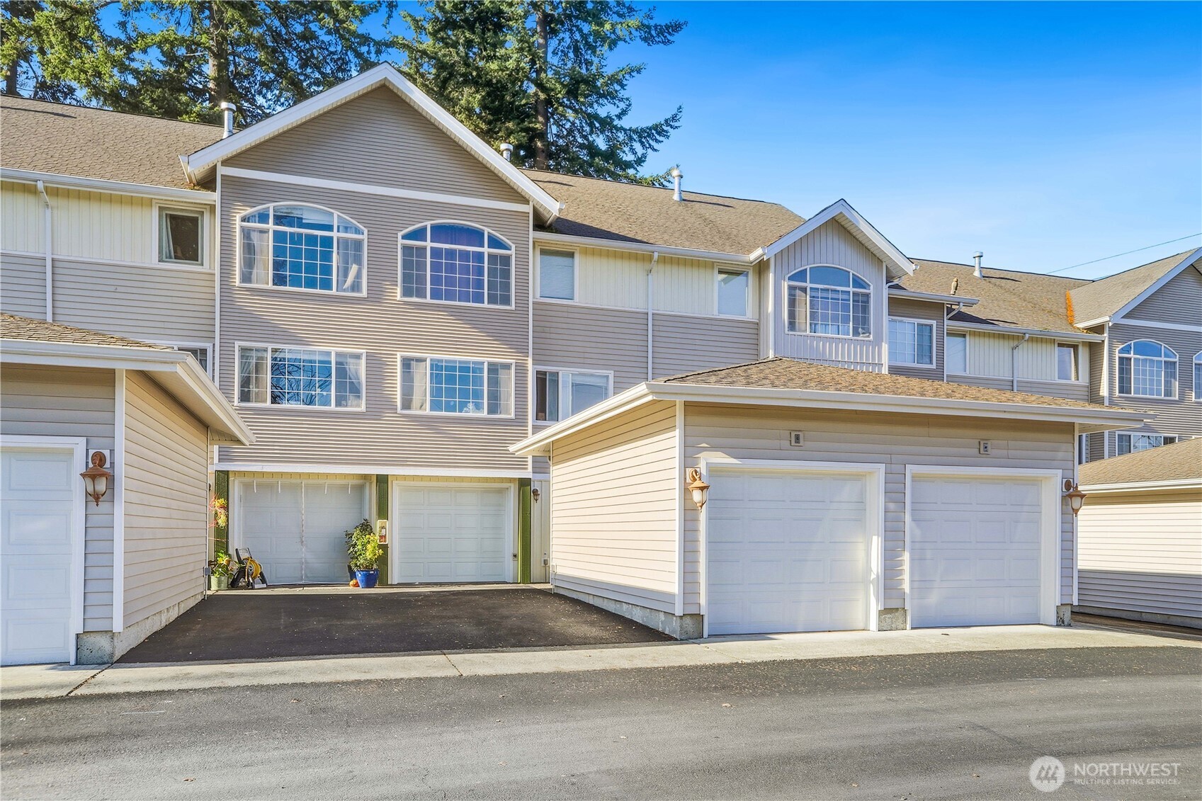 7818 228th Street Southwest, Unit 106 Edmonds, WA 98026 - Photo 16 of 19 a front view of a house with a yard and garage