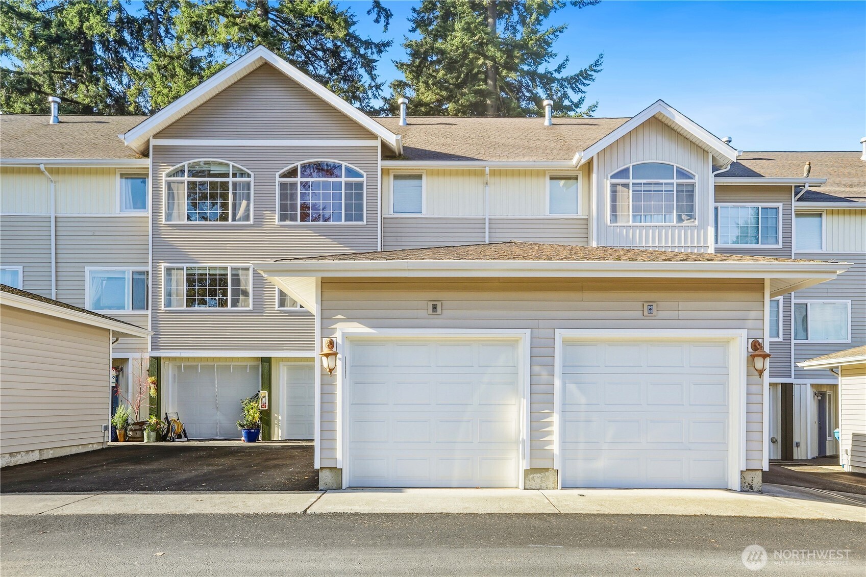 7818 228th Street Southwest, Unit 106 Edmonds, WA 98026 - Photo 17 of 19 a front view of a house with a yard and garage