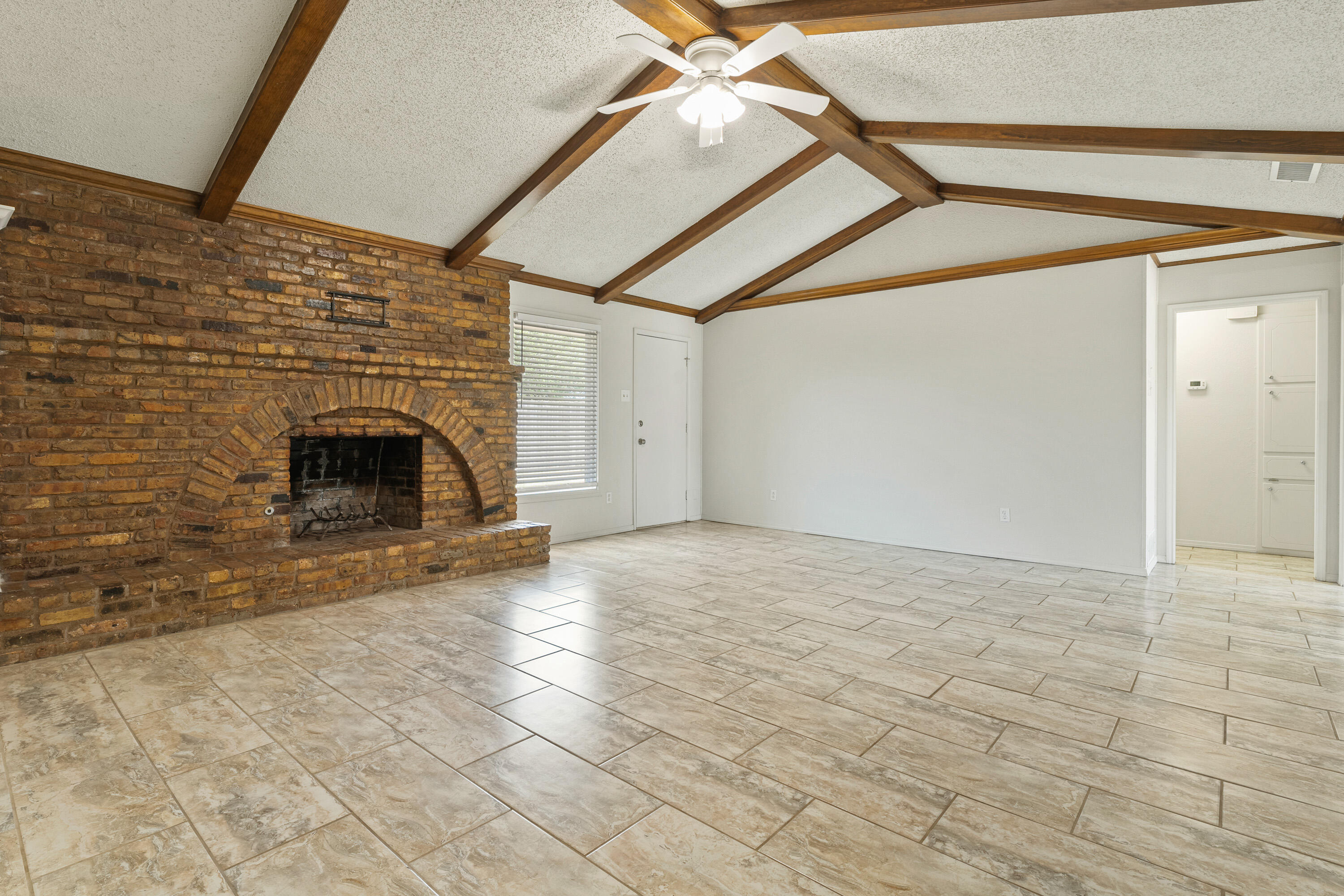 7004 Wayne Avenue Lubbock, TX 79424 - Photo 11 of 29 a view of empty room with fireplace and wooden floor