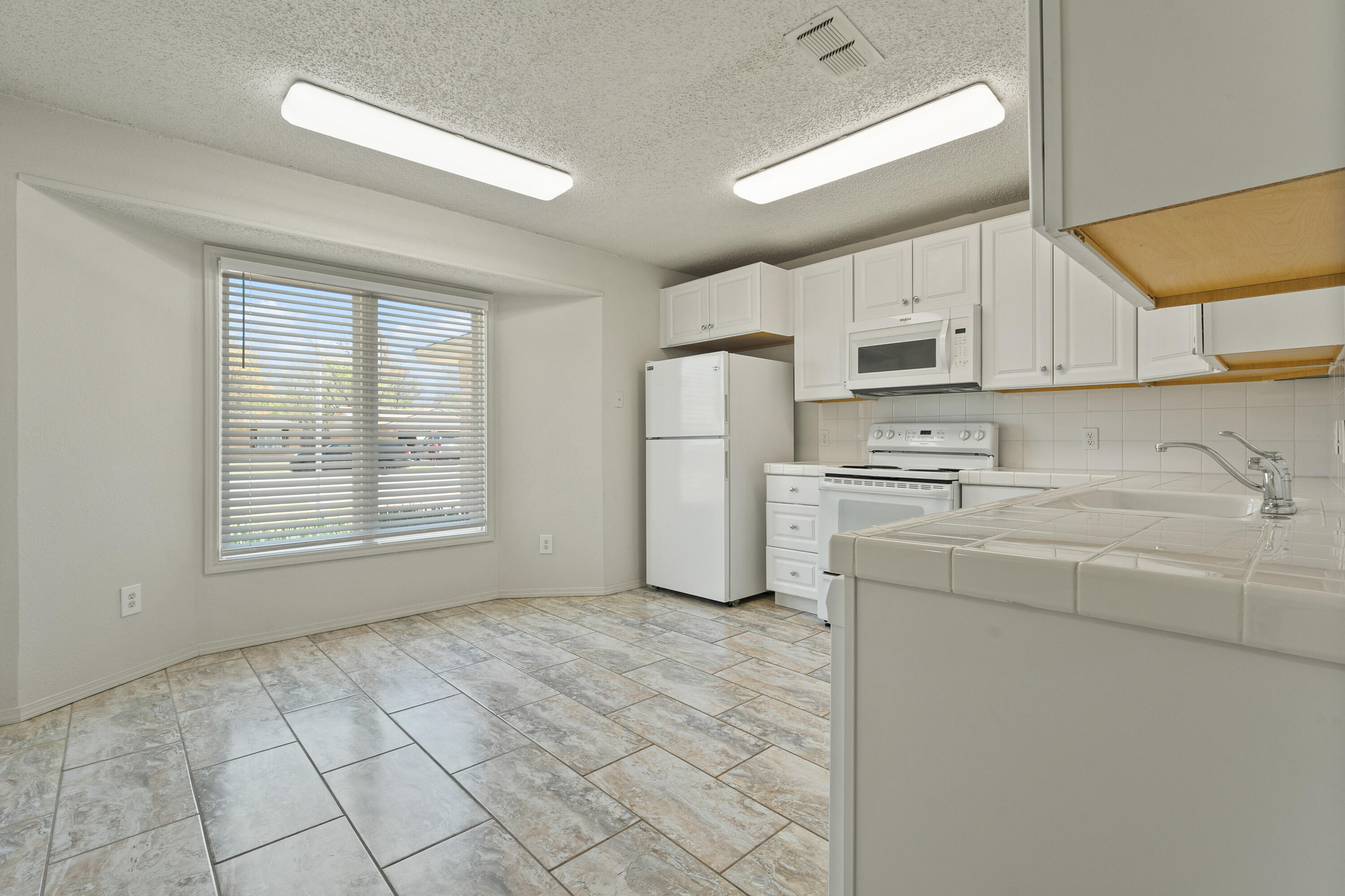 7004 Wayne Avenue Lubbock, TX 79424 - Photo 13 of 29 a kitchen with stainless steel appliances a refrigerator sink and cabinets