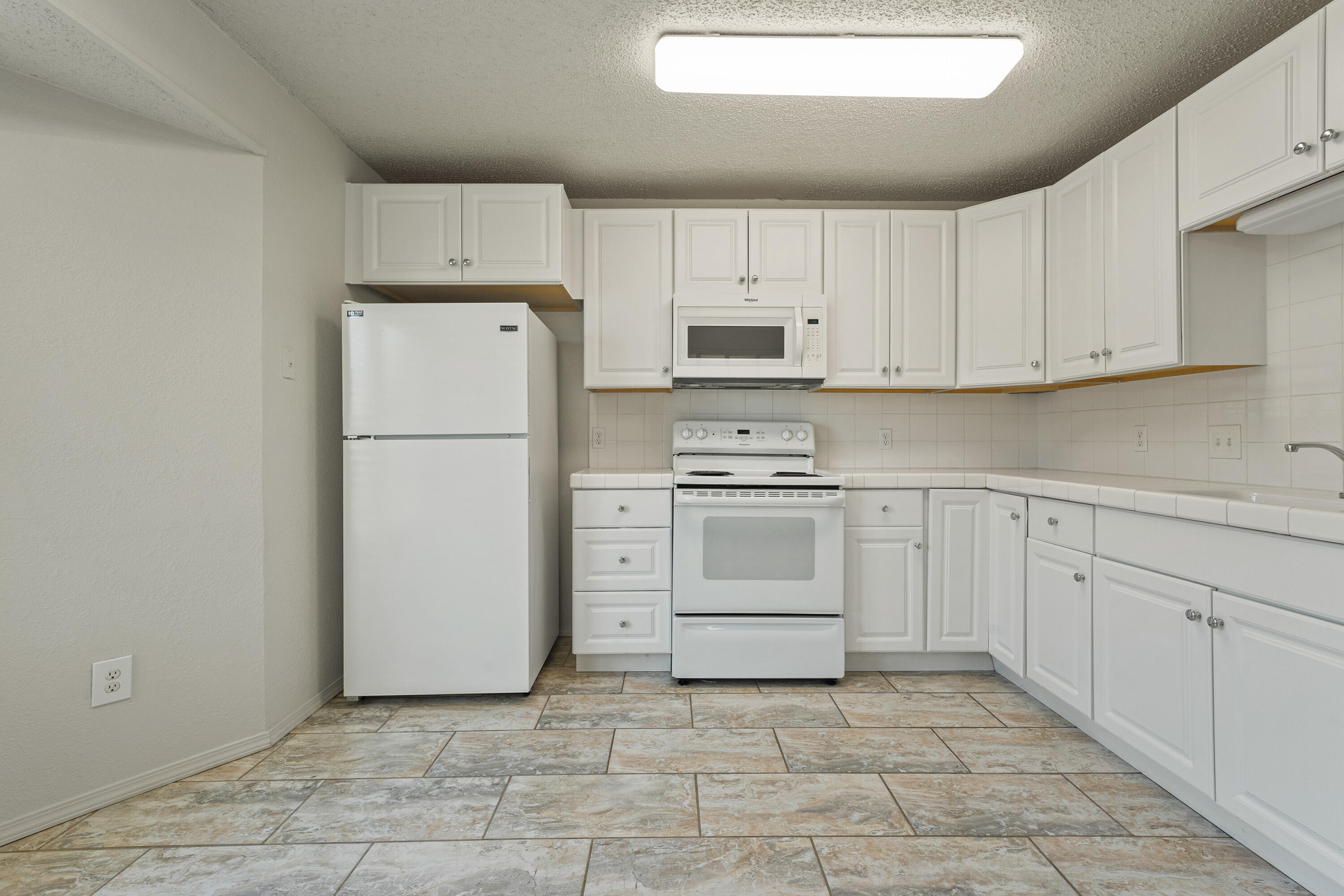 7004 Wayne Avenue Lubbock, TX 79424 - Photo 14 of 29 a kitchen with cabinets stainless steel appliances and a counter space