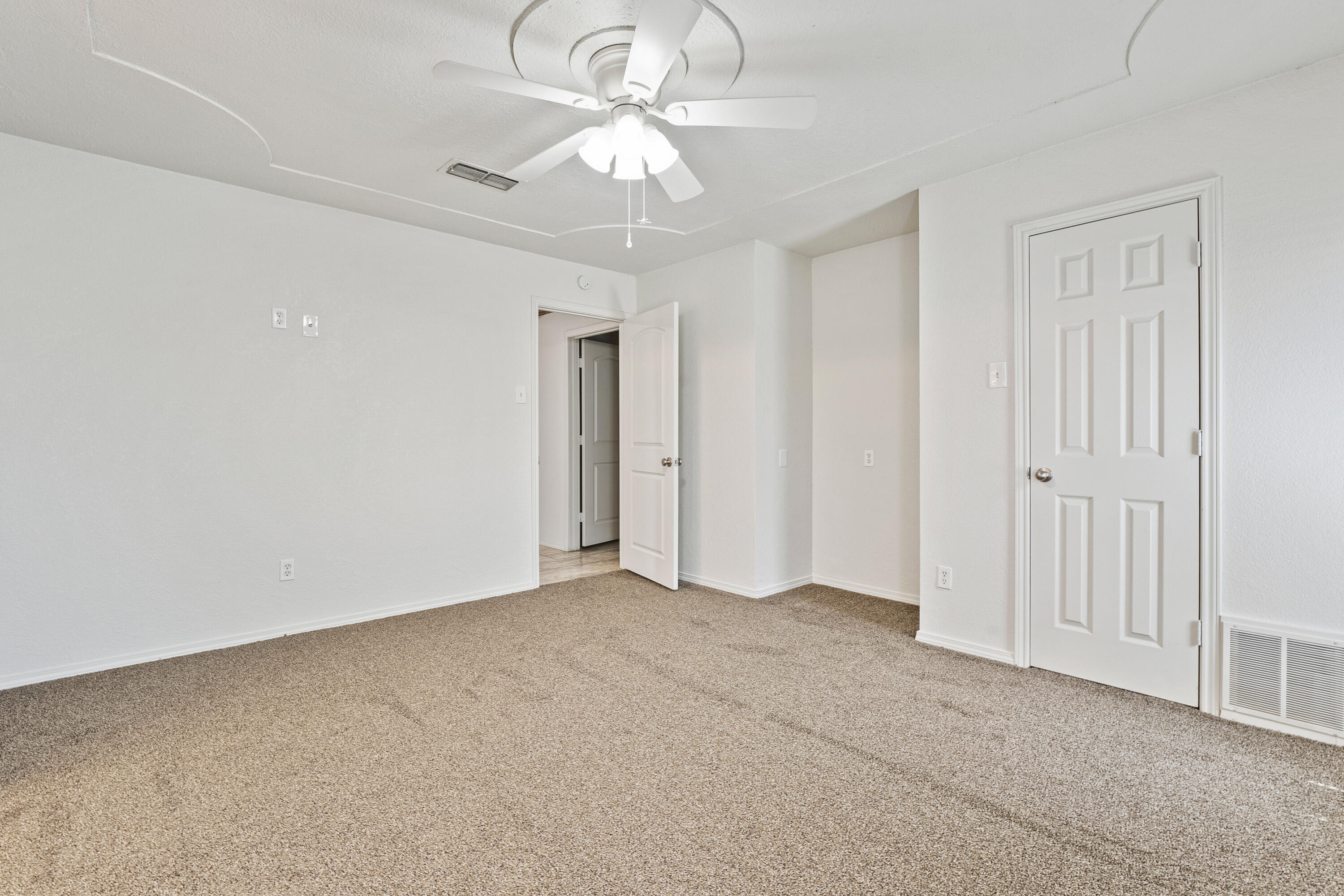 7004 Wayne Avenue Lubbock, TX 79424 - Photo 17 of 29 a view of an empty room with a chandelier fan