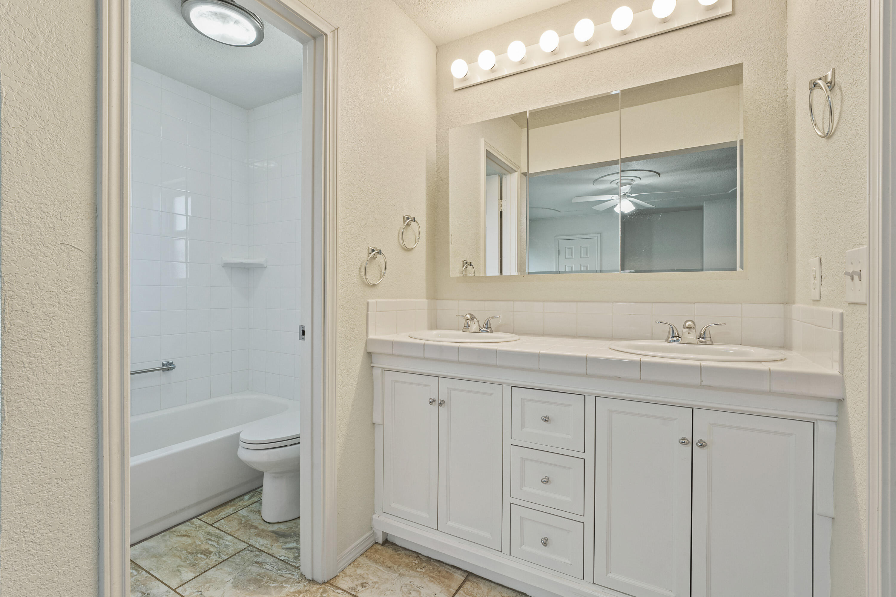 7004 Wayne Avenue Lubbock, TX 79424 - Photo 18 of 29 a bathroom with a granite countertop sink toilet and shower
