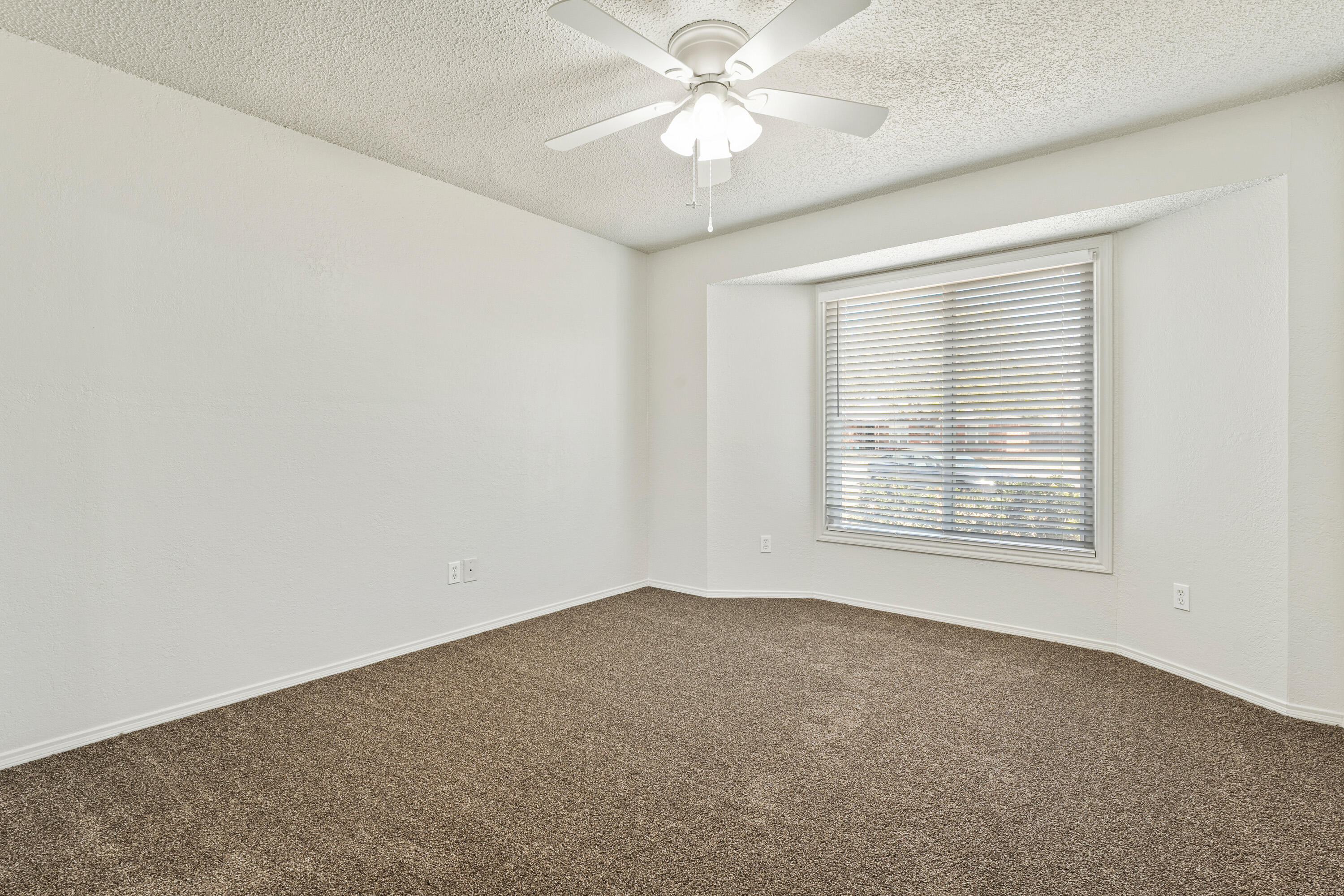 7004 Wayne Avenue Lubbock, TX 79424 - Photo 21 of 29 an empty room with a window and a fan