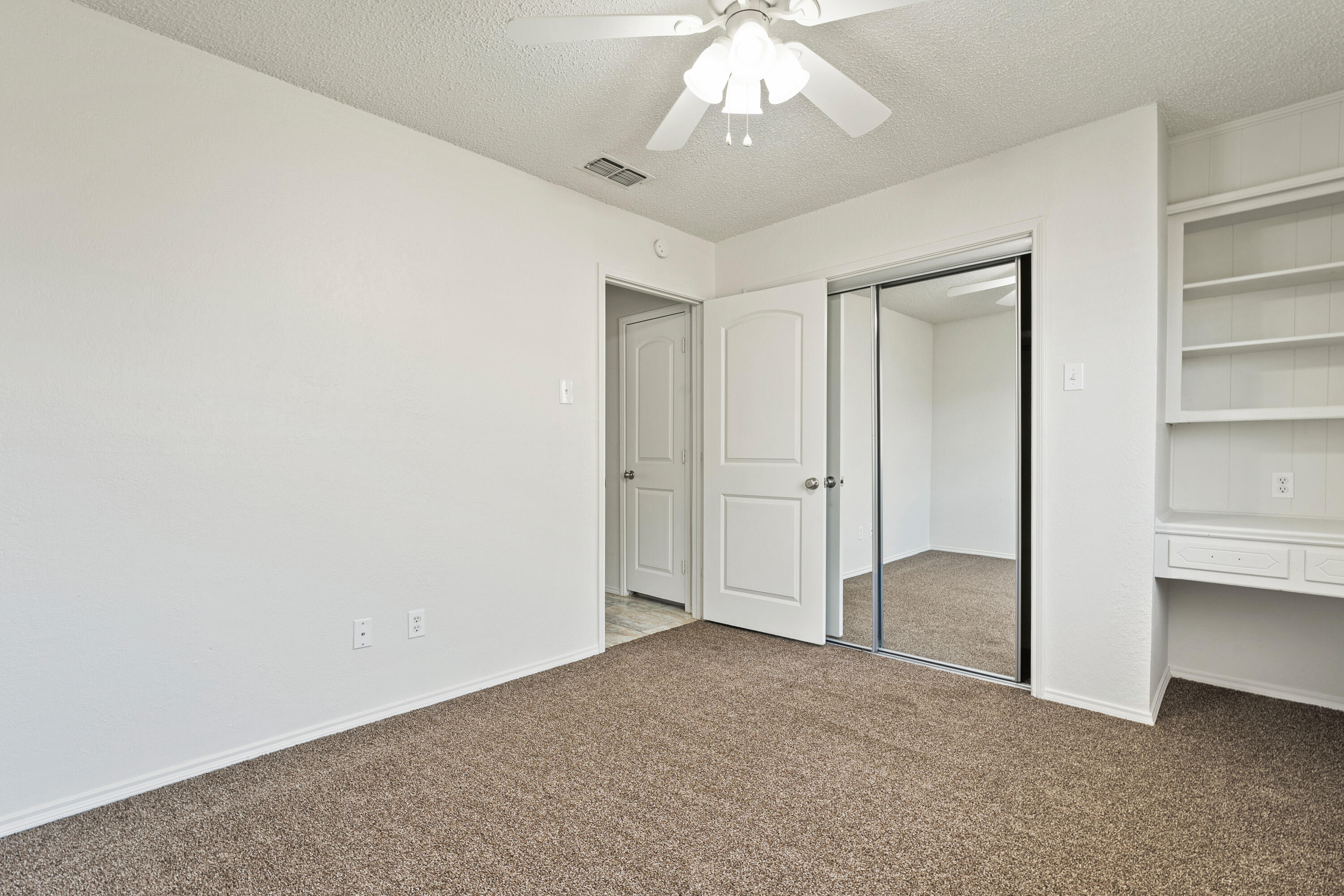 7004 Wayne Avenue Lubbock, TX 79424 - Photo 25 of 29 an empty room with chandelier fan