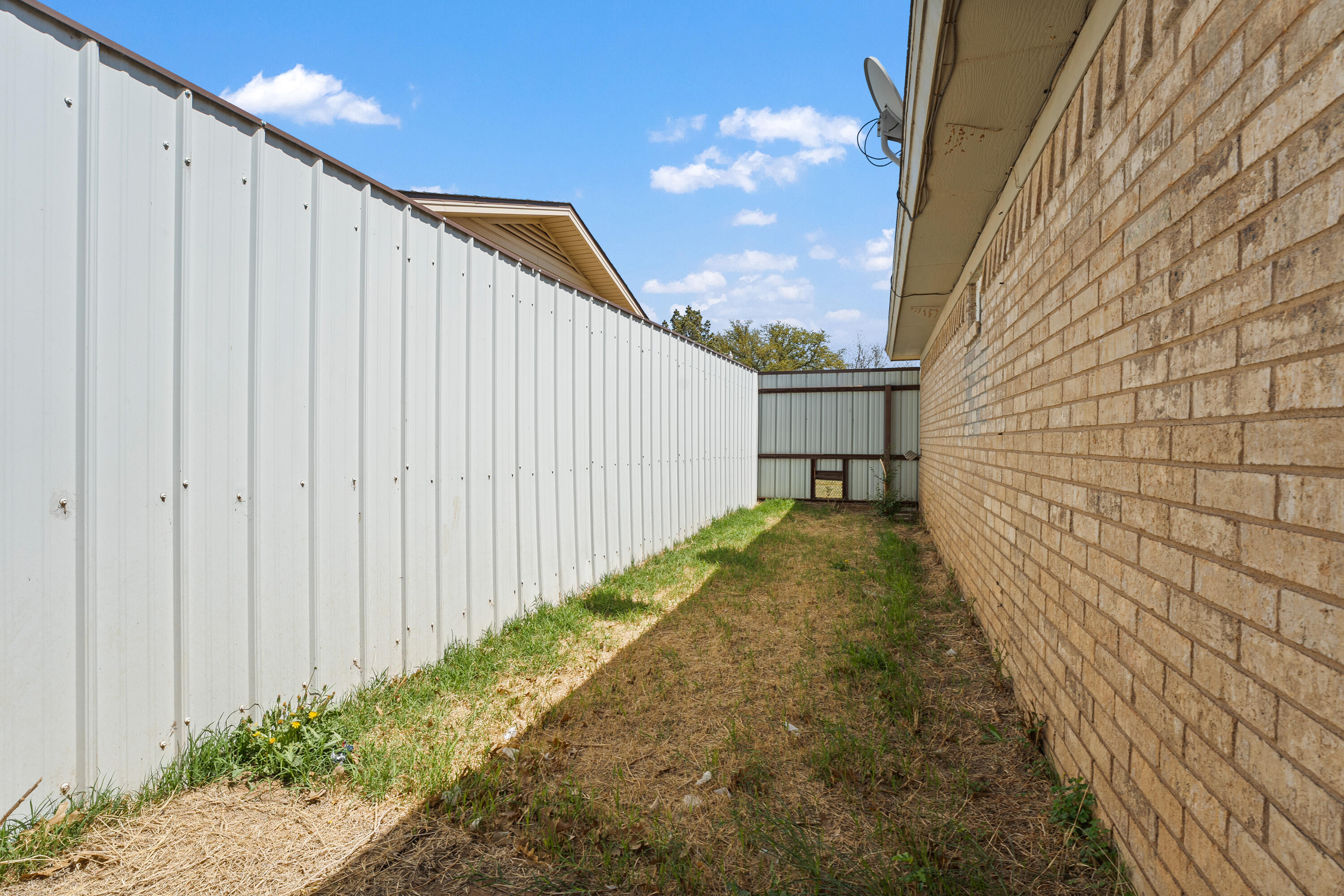 7004 Wayne Avenue Lubbock, TX 79424 - Photo 29 of 29 a view of a pathway gate with wooden fence