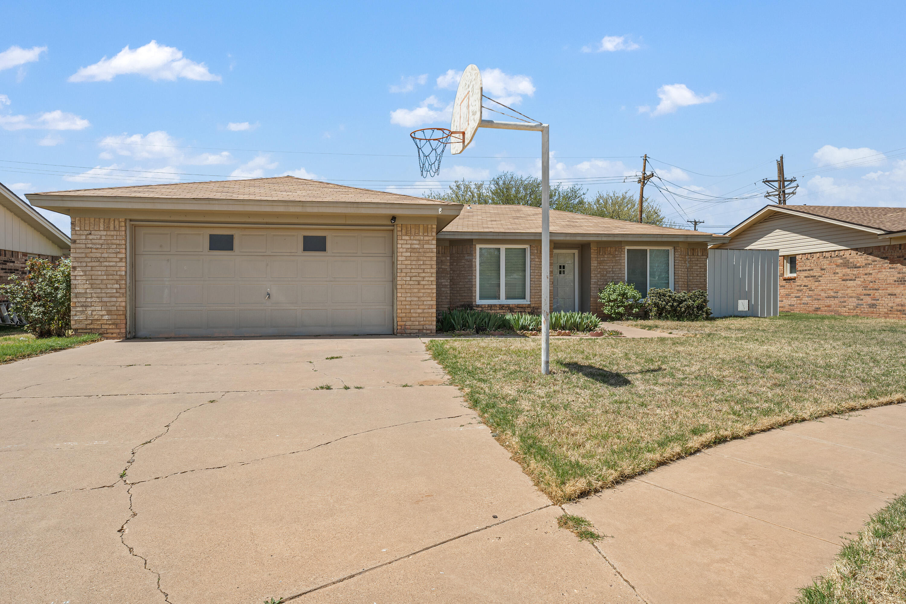 7004 Wayne Avenue Lubbock, TX 79424 - Photo 3 of 29 a front view of a house with a yard and garage