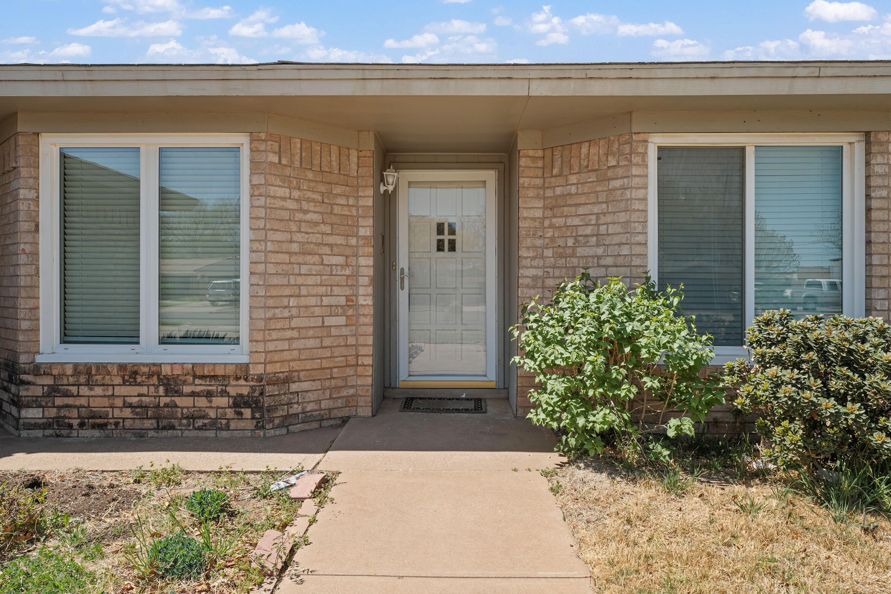 7004 Wayne Avenue Lubbock, TX 79424 - Photo 4 of 29 a front view of a house with a yard and garage
